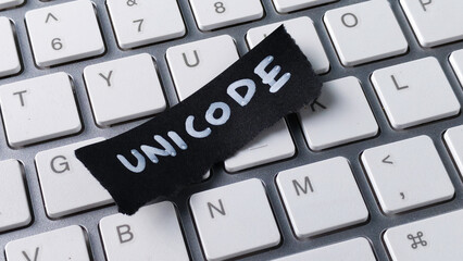 Unicode Encoding Standard Concept with Black Paper Note on Computer Keyboard Keys for Programming and Global Communication
