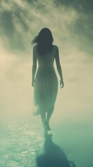 Woman walking barefoot through luminous mist outdoors
