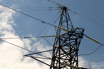 A High Voltage Power Transmission Tower Stands Tall Against the Beautiful Blue Sky Above