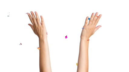 Raised hands throwing colorful party confetti celebrating success isolated on white background