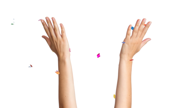 Raised hands throwing colorful party confetti celebrating success isolated on white background