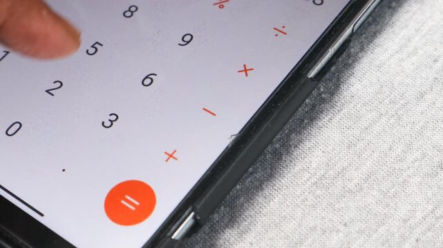 Person counts on a calculator of smartphone. Man counting accounting bills on phone.