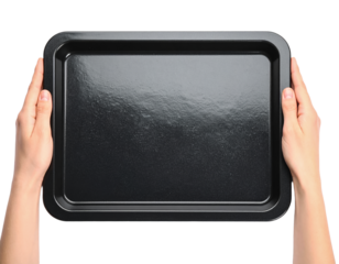 Hands holding black metal baking sheet tray kitchen utensil on transparent background