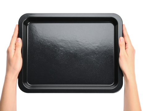 Hands holding black metal baking sheet tray kitchen utensil on transparent background