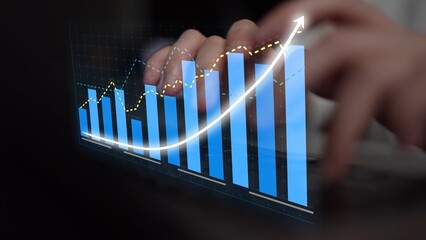 Close-up of hands typing on a keyboard, overlaid with vibrant financial graphs, showcasing significant growth trends and performance analysis in a business environment. Copula