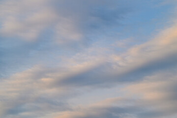 A Serene and Peaceful Sky Filled with Soft and Fluffy Clouds at the Beautiful Dusk Hour