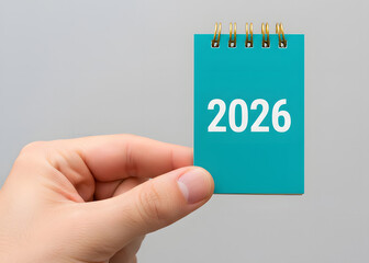 A man holds a notebook 2026 in his hands. Setting goals and objectives for the new year. Planning, business management and strategy concept. Trends, ideas and vision. New year 2026.