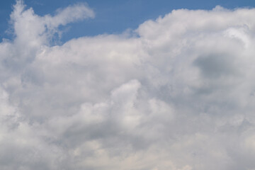 Beneath calm skies with fluffy clouds, the atmosphere feels peaceful and serene
