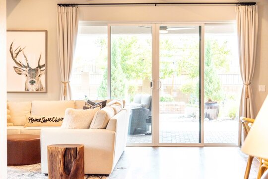 Spacious living room with sliding glass door to a lovely patio