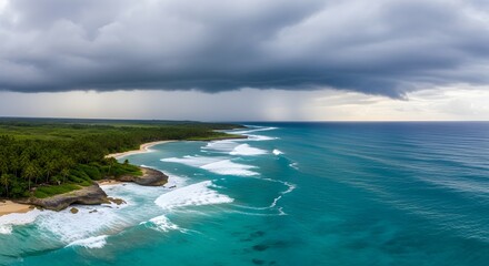 Fototapeta premium Turquoise ocean waves crash onto a lush green coastline under a dramatic stormy sky