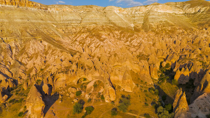 Goreme, Nevsehir, Turkey. Aerial view of unique red rock formations with intricate erosion patterns...
