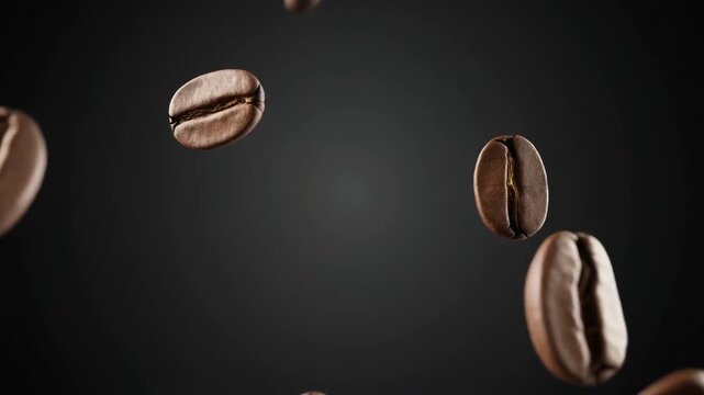 Aromatic roasted coffee beans cascading in slow motion, isolated against a sophisticated dark backdrop for a commercial