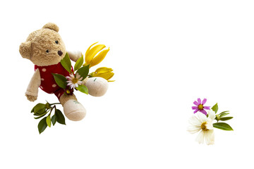 yellow flowers ylang ylang, cosmos with teddy bear toy arrangement flat lay postcard style 