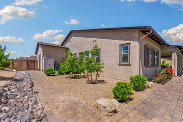 A charming house with a long gravel path leading up to it