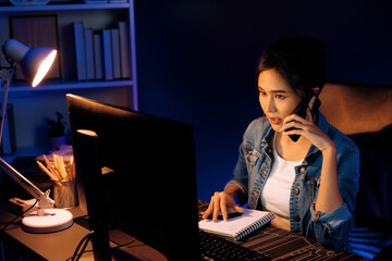 Young beautiful Asian creative woman calling on phone desk to customer or coworker explaining...
