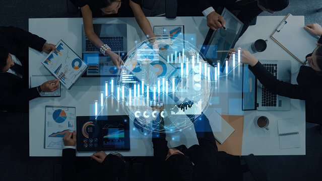 A diverse team of business professionals engages in a collaborative meeting focused on analyzing financial data, with modern tools and visual elements enhancing their strategic discussions. Scalp