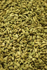 Green cardamom pods texture background showing whole elaichi spice seeds natural pattern closeup