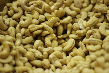 Raw cashew nuts texture background showing whole cream colored kaju natural pattern closeup