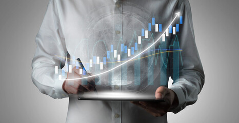 A business professional analyzes financial data using a tablet, highlighting trends with a digital graph. The image symbolizes technology-driven analytics in modern finance. Impute
