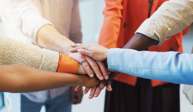 People, diversity or meeting with hands together for unity, trust or mission in office. Group, employees or multiracial team with pile, stack or huddle for community inclusion, solidarity or cohesion