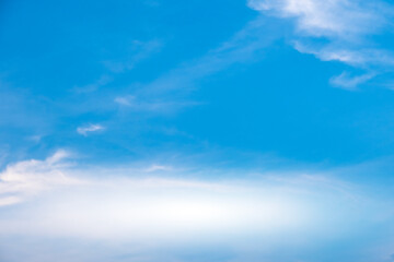 Obraz premium A bright, clear blue sky meets a glowing white horizon, suggesting a serene, open, and with sunlight of beautiful cloudy sky. landscape or abstract background. 