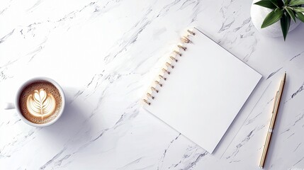 A clean and organized workspace featuring a cup of coffee with latte art, an open notebook, a pen, and a small green plant on a marble surface.