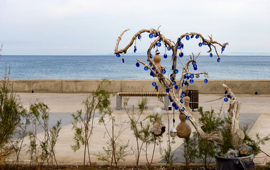 Mythological Tree of Protection Adorned with Hundreds of Traditional Blue Evil Eye Charms, Standing...