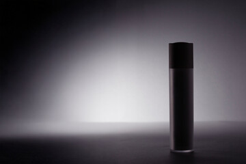 Minimalist silhouette of a cosmetic bottle glowing under intense light. A conceptual representation of cosmetic cream, serum and etc Copy space