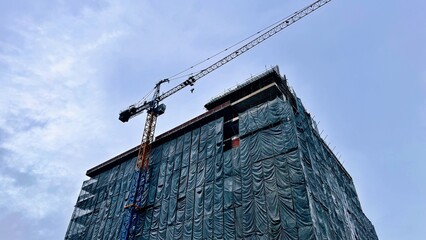 High-Rise Building Construction Site with Tower Crane and Safety Net Cover, Construction site 
