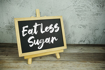 wooden easel displays a blackboard with the bold white text 