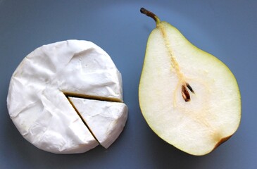 Brie wheel beside halved pear