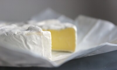 Creamy camembert wheel on parchment paper