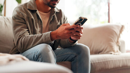 Hands, mobile and man relax in home for online dating, social media profile and post. Smartphone,...