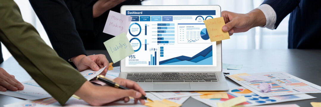 Analyst team use sticky note for creative and analytic brainstorm for business idea with BI data dashboard on laptop screen. Analysis financial data visualization tech for marketing strategy. Prodigy