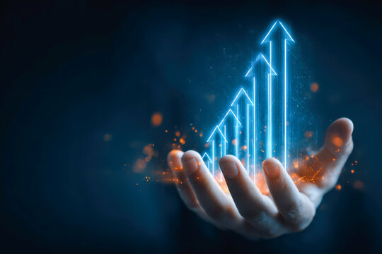 Hand holding glowing futuristic digital arrows pointing upward symbolizing growth, progress, and success in business or technology advancements in a dark background