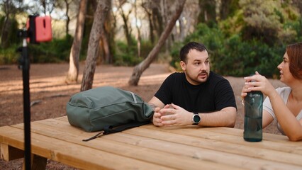 Influencer couple live streaming discussion on social media for travel blog