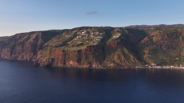 Sunset aerial view over ocean of Faja da Ovelha civil parish in Calheta, Madeira