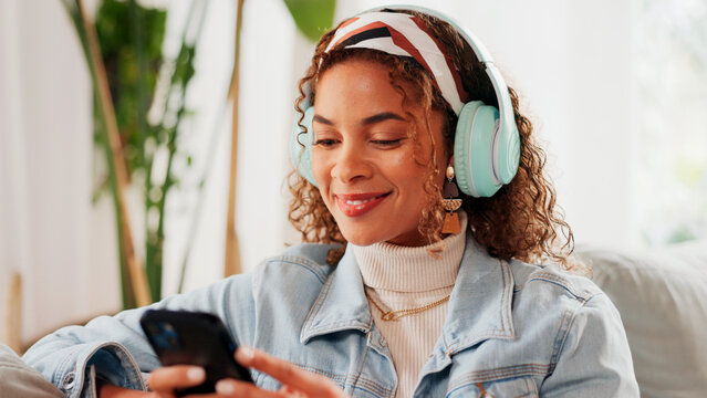 Relax, woman or phone with headphones on sofa for social media video, music album or weekend break. Smile, person and smartphone in home for listening to podcast, sound playlist and streaming service - Powered by Adobe