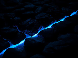 Abstract glowing blue light path through dark rocks, modern technology concept