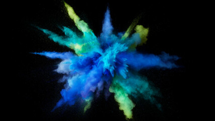 Blue and green powder explosion against a black background