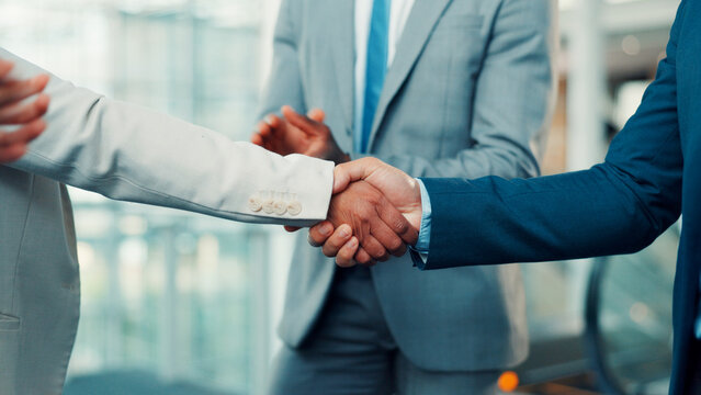Business people, meeting and team with handshake for deal, agreement or partnership in office. Group, employees or colleagues shaking hands for b2b introduction, onboarding or welcome in workplace