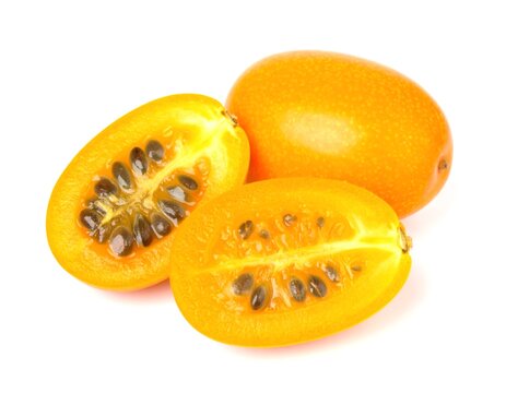 Tumbo fruit sliced open revealing seeds against white backdrop