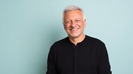 Obraz premium Happy senior man smiling on blue background