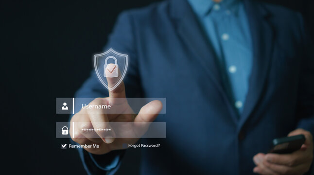 Cybersecurity login concept with businessman touching a virtual shield icon on a digital authentication screen, emphasizing secure access, password protection, identity verification, and data safety.