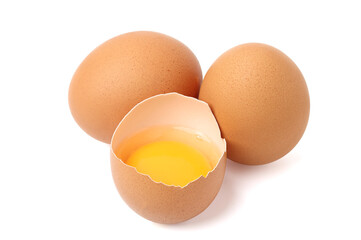 Fresh peeled chicken eggs reveal a bright yellow color and a full egg on the side. isolated on white background.