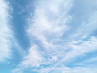 Soft blue sky with gentle white clouds creating a calm, airy, and minimal background perfect for design, nature themes, and serene atmospheres.