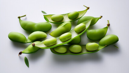 Several edamame pods arranged simply on clean white background