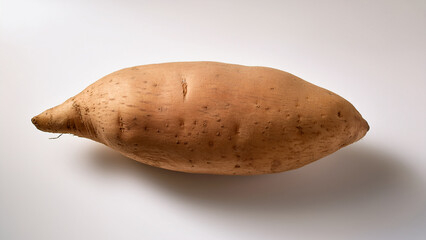 A whole yam with earthy texture on a clean white backdrop