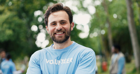 Happy man, portrait and park with volunteer for eco friendly development or global change in...