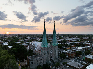 Fototapeta premium Sunset aerial view of church spires over Montreal cityscape. g.